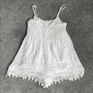 Flowy white romper with crotchet detailing